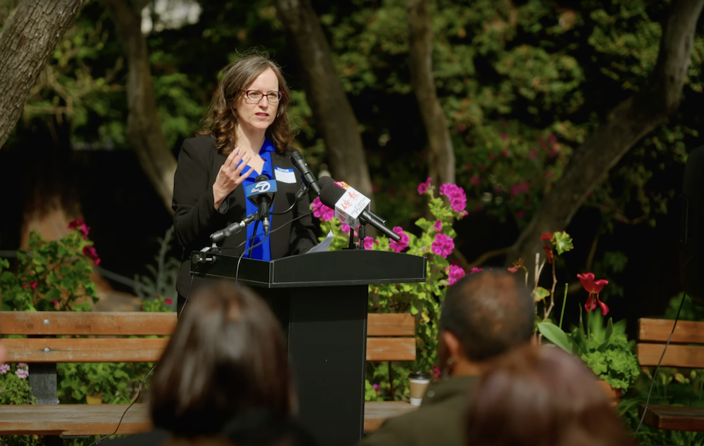 Rebecca Sudore, MD, speaks to a group outdoors.