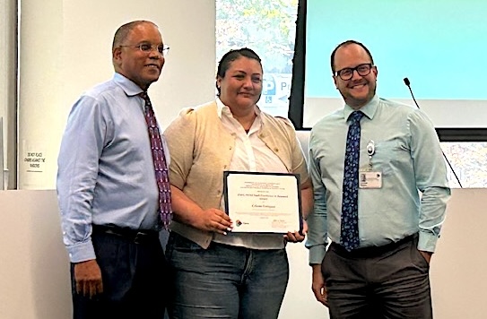 Celeste Enriquez accepts the Department of Medicine Staff Excellence Award from Dr. Neil Powe, leader of UCSF Medicine Service at the Priscilla Chan and Mark Zuckerberg San Francisco General Hospital.